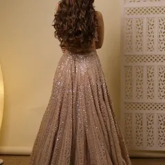 A back view showing the beautiful open hairstyle with voluminous curls, perfect for a glamorous evening event.