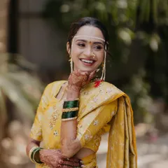 The pure happiness of a Maharashtrian bride. This look is all about a natural, dewy glow that complements the traditional yellow saree and gold jewelry.