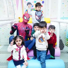 A photo opportunity with a real superhero! Spider-Man takes a moment to pose with the birthday boy and his friends in the play area.