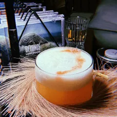 The 'Girls Just Wanna Have Fun' cocktail, a pop coded drink perfect for brunch. I styled this shot to capture its fun, girly vibe, placing it against the pampas grass and the Beyoncé 'Lemonade' album for context.