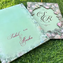 A complete view of this nature-inspired suite. The laser-cut cover and the main insert with the couple's names come together to create a cohesive and truly memorable piece.