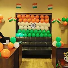 An office cabin gets a patriotic makeover with a balloon backdrop in the shape of the Indian flag. Small flag buntings and balloon clusters complete the festive look for a Republic Day office party.