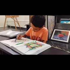Another young student practicing his drawing skills, demonstrating the foundational techniques we teach.