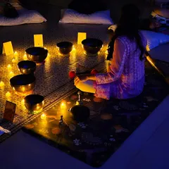 A view from a group sound bath, where everyone finds their own comfortable space. The collective energy in the room, combined with the candlelit ambiance, enhances the deeply calming experience for all.