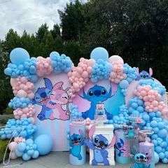 We love creating decor based on beloved characters. This vibrant gender reveal party is themed around Stitch and Angel, using a dense arrangement of pink and blue balloons and character cutouts to create a playful and immersive experience.