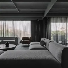 A close-up of the living area, detailing the texture of the sofa fabric and the clean lines of the surrounding architecture.