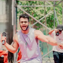 On the mic, hyping up the crowd at a huge Holi party. My job is to be an entertainer, and I bring my full energy to get thousands of people celebrating together.