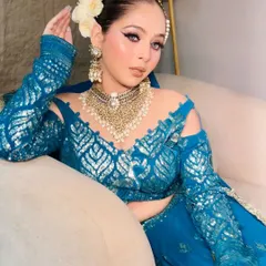 A close-up of the teal blue outfit, showing the heavy pearl and kundan choker that comes with it.