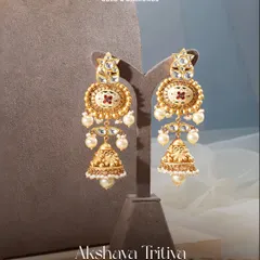 These jhumkas sway with the strength of tradition and the grace of modern elegance. Crafted with matte gold, enamel work, and pearls, they are a promise of pure blessings in every piece.