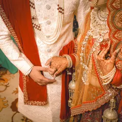 A detail shot of Rohit and Neha holding hands during their wedding ceremony. This classic photo symbolizes their union and the start of their new life together.