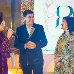 Sharing a lighthearted moment with the happy couple at their 25th anniversary celebration. Their smiles show a love story that's truly inspiring.