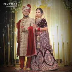 This is a perfect example of a coordinated couple's look for the wedding day. The groom is wearing a beige and red embroidered sherwani that perfectly complements the bride's velvet lehenga.