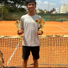 Svar with his Singles Finalist and Doubles Winner trophies from the TS7 Under 14 at Tennis Arena, Bangalore.