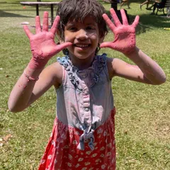 A young participant showing off her colorful hands during our Holi festival. It was a day for messy, loud fun and making memories that will last long after the colors fade.