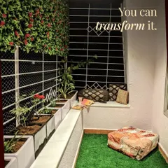 This cozy reading nook is proof that any balcony can be transformed. With artificial turf, planters, and a vertical flower wall, it's now a perfect spot to de-stress.