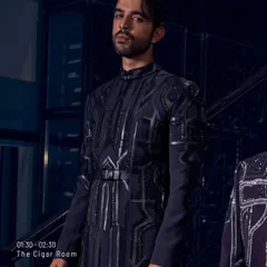 Midnight tailored, memories handcrafted. This belted jacket with its pleated details and geometric embroidery is for the man whose walk says everything long before he speaks.