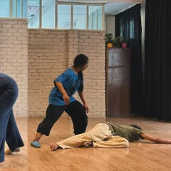 A moment of connection and support during an improvisation exercise. We learn to give and take weight, both physically and emotionally.