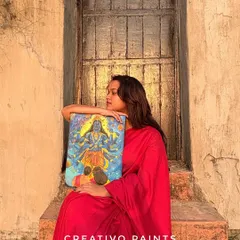 Holding the finished Lord Vishnu painting. This piece was a joy to create, and I love how the colors pop in the natural sunlight.