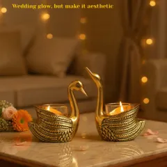 A pair of my brass swan t-light holders, bringing a sense of grace and romance to the setting. They are a beautiful symbol of togetherness, perfect for a wedding celebration.