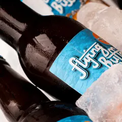 Nothing says refreshing like a beer on ice. This close-up shot for Flying Buffalo focuses on the interaction between the cold bottle and the ice, creating a powerful sensory image.