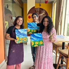 A group of happy painters with their finished sunflower canvases. It's amazing how different and beautiful each one turned out.
