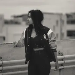 This black and white urban portrait has a raw, documentary feel. The rooftop setting and the subject's direct gaze create a powerful image that feels both candid and composed.