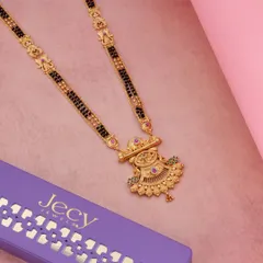 This image displays a traditional gold mangalsutra next to its elegant purple packaging, making it an ideal shot for product listings that want to highlight the complete offering.