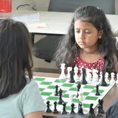 The deep concentration on a student's face as she plans her next move. Our camp is not just about learning rules; it's about developing focus, patience, and critical thinking skills.