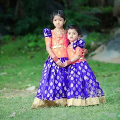 I designed these coordinating Pattu Pavadai outfits for two sisters. While the skirts match, the blouse designs are slightly different, giving each girl her own unique look while still looking like a perfect pair.
