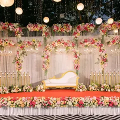 Melvin and Marilyn wanted a dreamy, fairytale reception. I used a soft pastel floral palette to create these enchanting arches over the main stage, complemented by hanging lanterns and chandeliers for a truly magical, starlit evening.