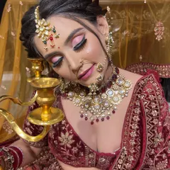 The richness of a velvet bridal lehenga calls for equally luxurious makeup. This look features deep, sultry eyes and a perfectly contoured base, creating a regal and unforgettable appearance for the bride's D-Day.
