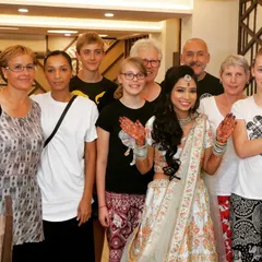 We love capturing moments with guests. Here, the bride poses with international guests, showing how weddings bring people together.