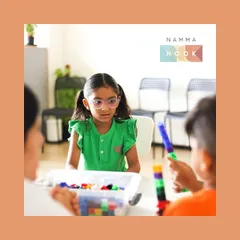 A young girl at one of my workshops, focused and curious as she interacts with the learning materials. My goal is to spark this kind of natural curiosity in every child.