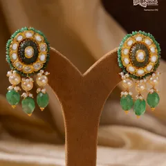 When light chooses luxury. These Moissanite Mirage earrings, studded with handpicked moissanite stones and accented with emeralds and pearls, radiate an unmatched sparkle. They are a showcase of exceptional craftsmanship in 22ct gold.
