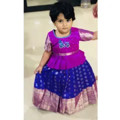 I love mixing traditional fabrics with modern styles. This Pattu Pavadai features a trendy peplum top over a classic silk skirt, and I added a custom bicycle embroidery for a personal, whimsical touch.