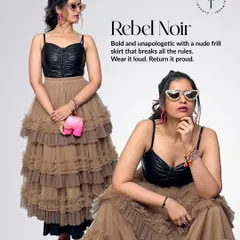 This is 'Rebel Noir'. I've paired the same faux leather bustier with a tiered nude frill skirt for a look that's both tough and feminine. The pink elephant clutch adds a quirky, unexpected pop of color.