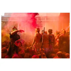 A devotee throws colored powder over the crowd during Holi celebrations. The air becomes thick with color, creating a hazy, dreamlike atmosphere that I love to photograph.