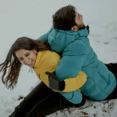 Pure, uninhibited laughter during a playful moment in the snow. These are the candid shots that truly reflect a couple's personality and connection.