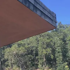 A detail shot from our Uttarakhand project, showing the sharp edge of the shingled roof against the dense forest backdrop. This image captures the essence of the design: creating clean, modern forms that respectfully coexist with their natural environment.