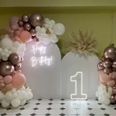A closer look at our modern and elegant first birthday setup. The combination of chrome rose gold and pastel pink balloons with dried pampas grass creates a sophisticated, bohemian-inspired look.