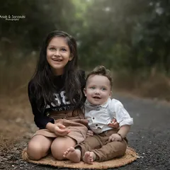 A proud big sister with her adorable baby brother during an outdoor sibling photoshoot. We love capturing the unique personalities and growing friendship between siblings.