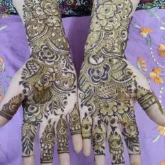 A classic party mehndi design for both hands. The patterns are asymmetrical, giving each hand its own unique personality while still looking like a beautiful pair.