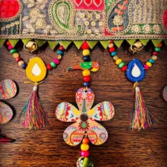 Another detail shot of the 'Taana Baana' toran. I love how the bright tassels and hand-painted flowers pop against the intricate lace. The little ghungroos add a gentle sound with every breeze.
