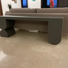 Another view of the expedited console table, highlighting its clean lines and unique, balanced form.