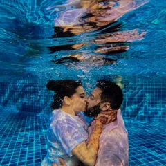 Taking the plunge, quite literally. This underwater kiss during a pool party is a perfect example of how I love to push creative boundaries to capture unique and unforgettable moments that truly reflect a couple's playful spirit.