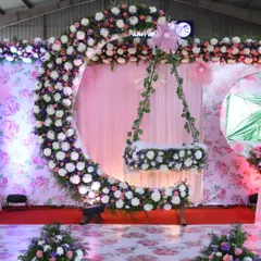 I love making naming ceremonies magical. This moon-shaped cradle design, adorned with a cascade of fresh flowers against a floral print backdrop, creates a dreamy setting to welcome a new baby.