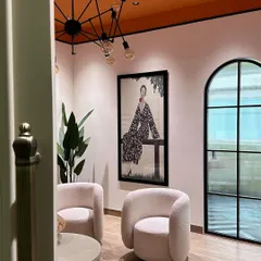 A glimpse into our studio's lounge area, designed to be a comfortable and inspiring space for our team and clients, with an orange ceiling and curated art.