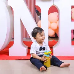 A candid moment of the birthday boy exploring his party. These natural shots capture his budding personality and curiosity.