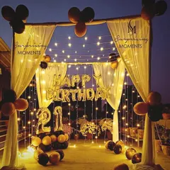 For a grand 21st birthday, I set up this stunning canopy on a terrace. The backdrop of fairy lights, gold "HAPPY BIRTHDAY" balloons, and a black and gold theme made for an unforgettable outdoor celebration.