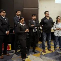 Our team members stand with guests during the charity lunch for the Spastic Society of Karnataka. These events are a collaborative effort filled with heart.
